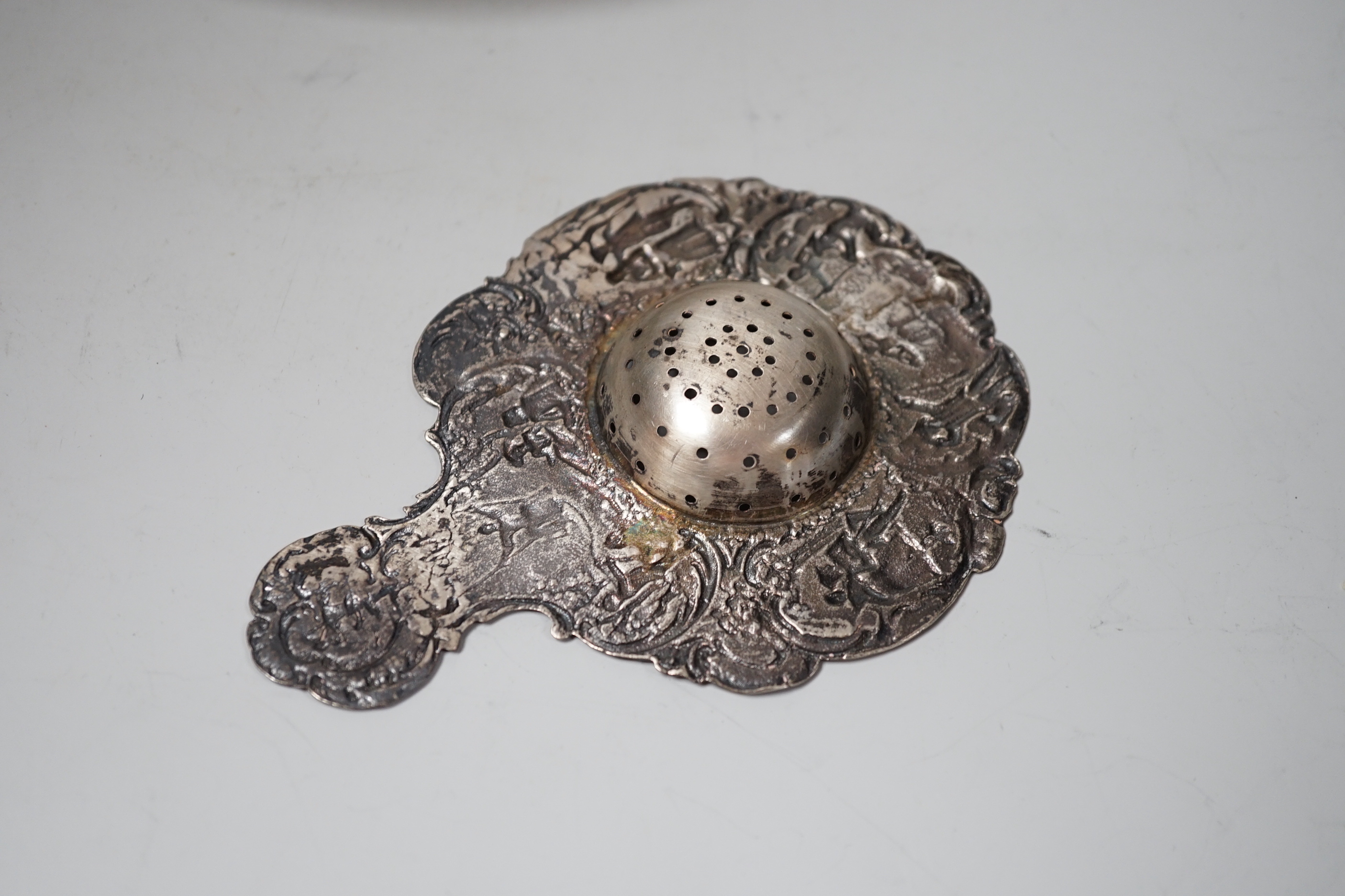 A late Victorian silver tea strainer, import marks for London, 1900 and a pierced silver plated bowl.